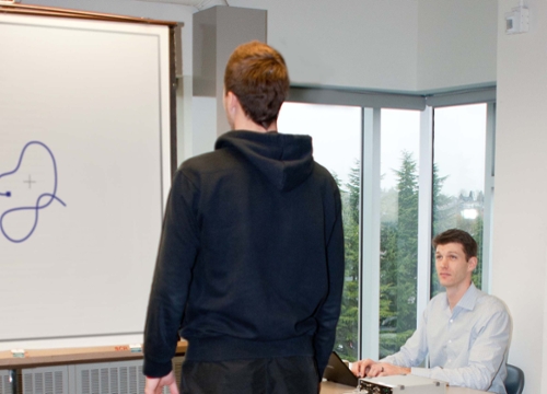 Ryan Cawsey works with a student volunteer on a project investigating postural control.